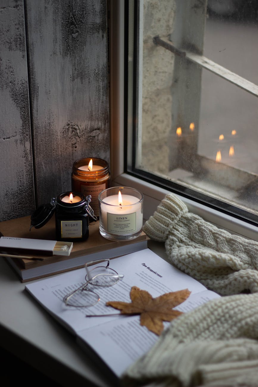 a lighted candles by the window
